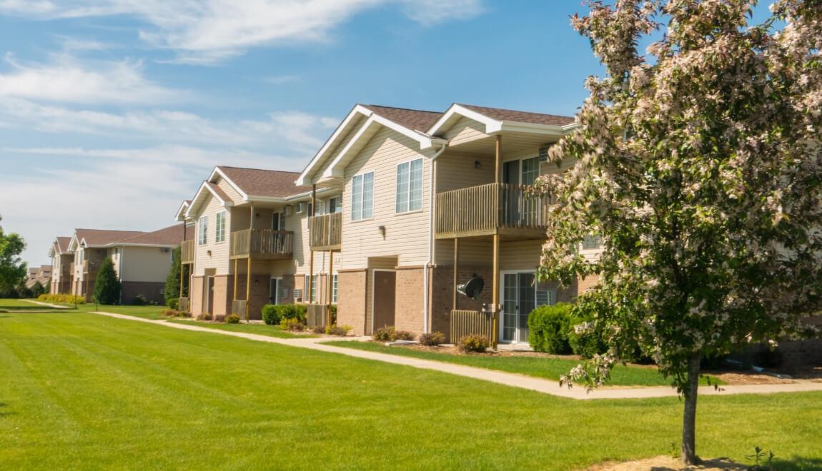 Garden apartments with lawn and sidewalk