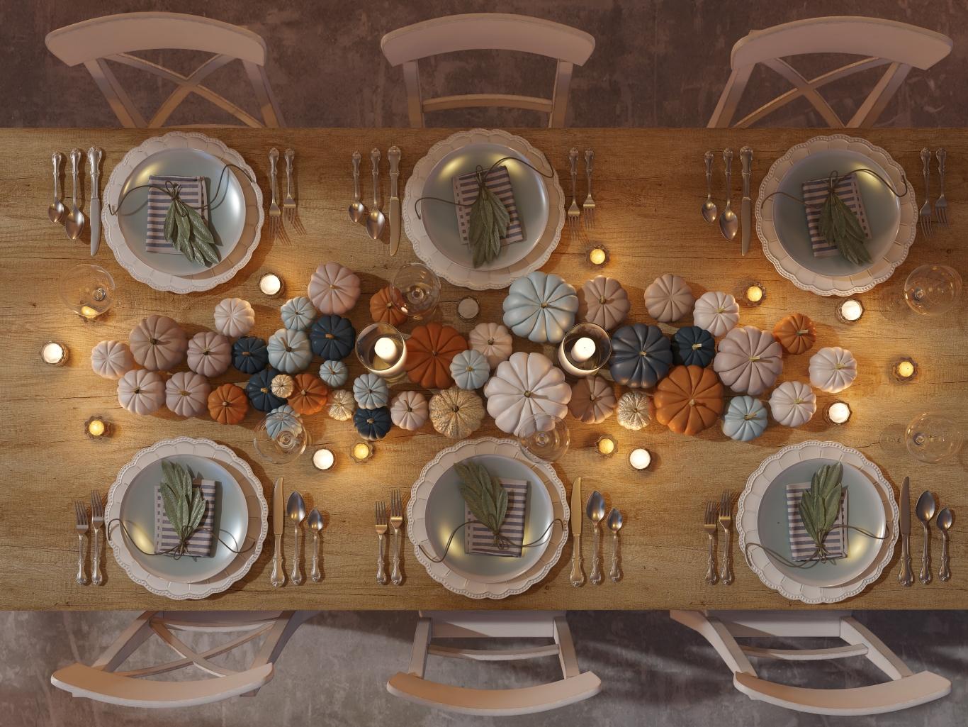 Overview of an elegant table with a variety of pumpkins as decor.