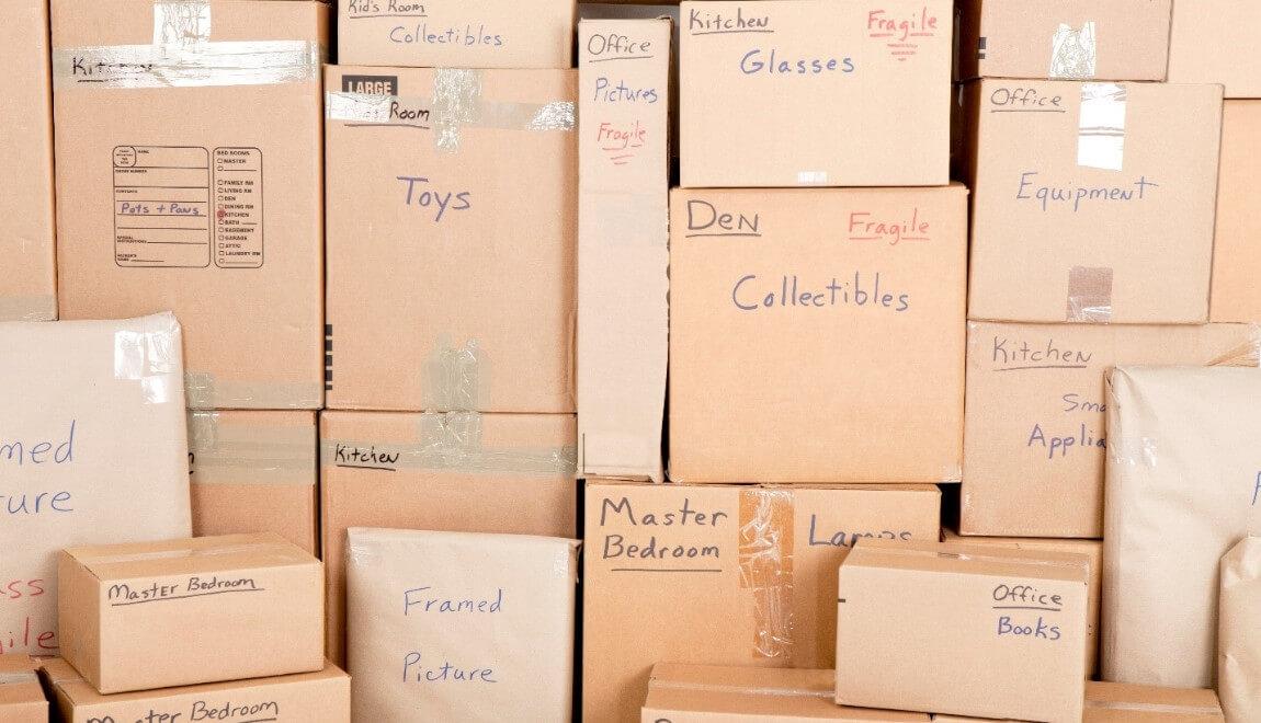 A stack of moving boxes, labeled with the contents