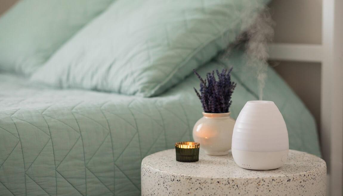 a bedside table displays an essential oils diffuser