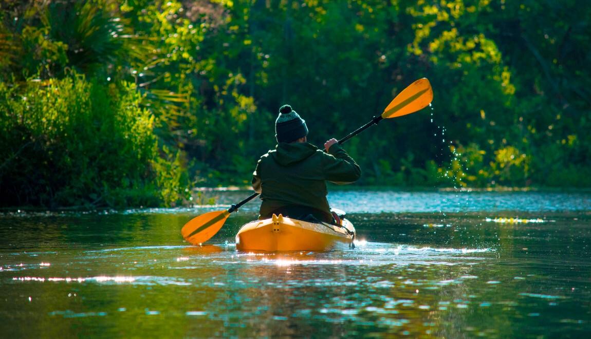 A person kayaks along the St. Johns River in Orlando, Florida.