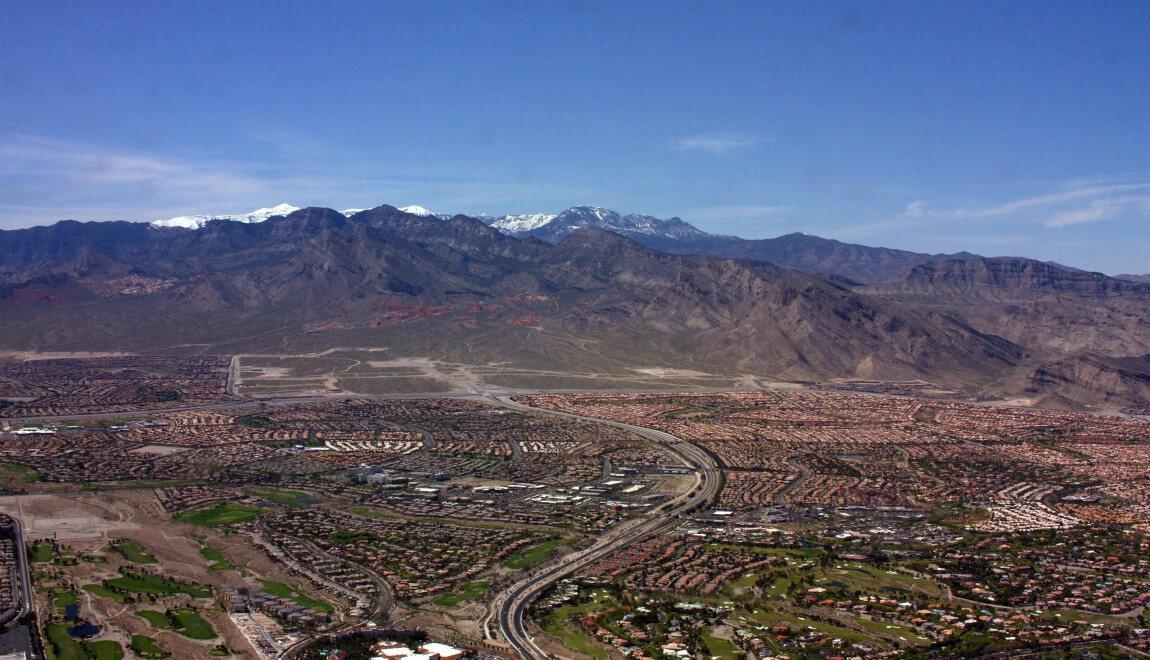 An aerial view of Las Vegas and mountains.