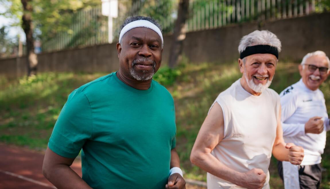 A group of older men jogging together.