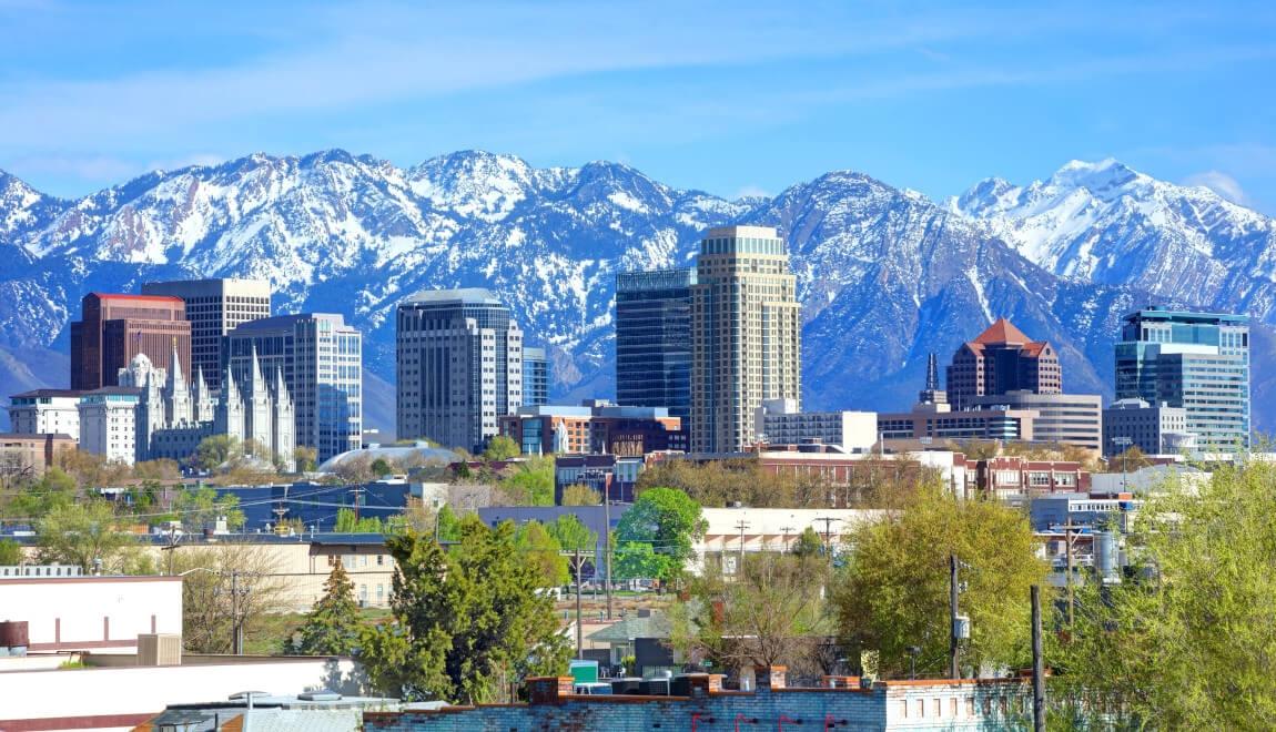 Salt Lake City's impressive skyline against a backdrop of snow-capped mountains.