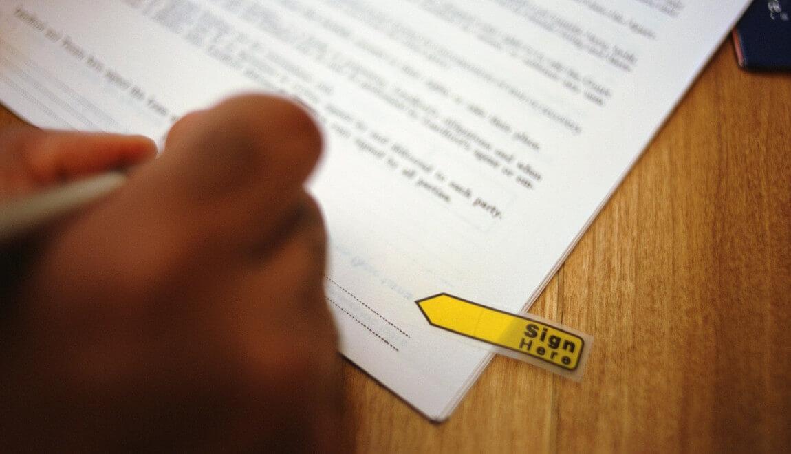 A yellow arrow points to where a signature is required. 