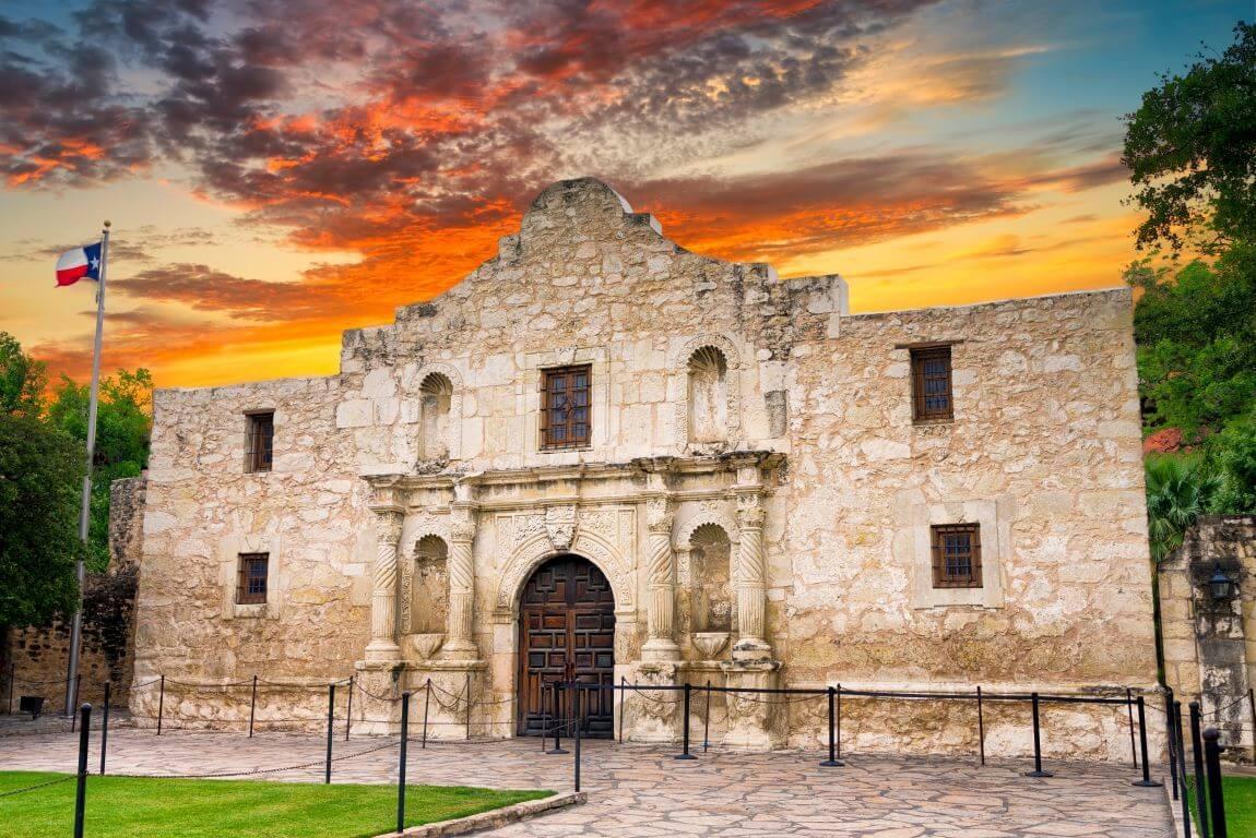 The Alamo against a bright sunset