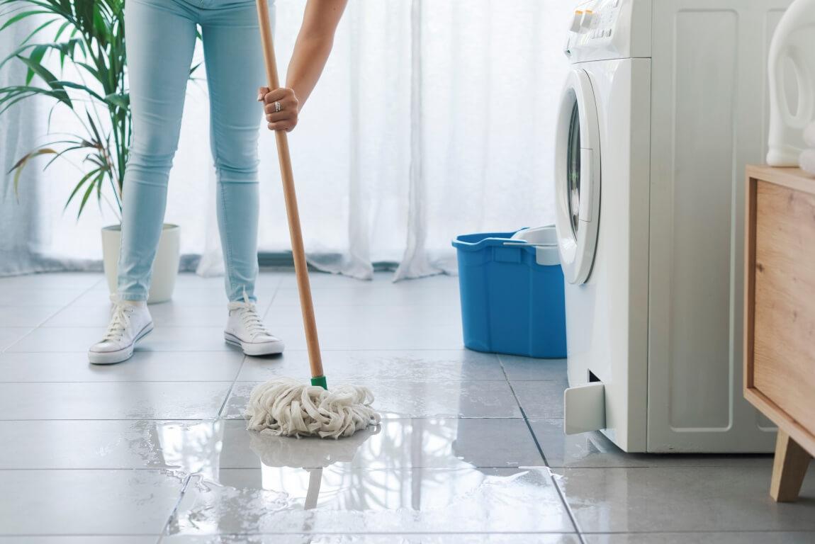 An image of a person mopping the floor. 