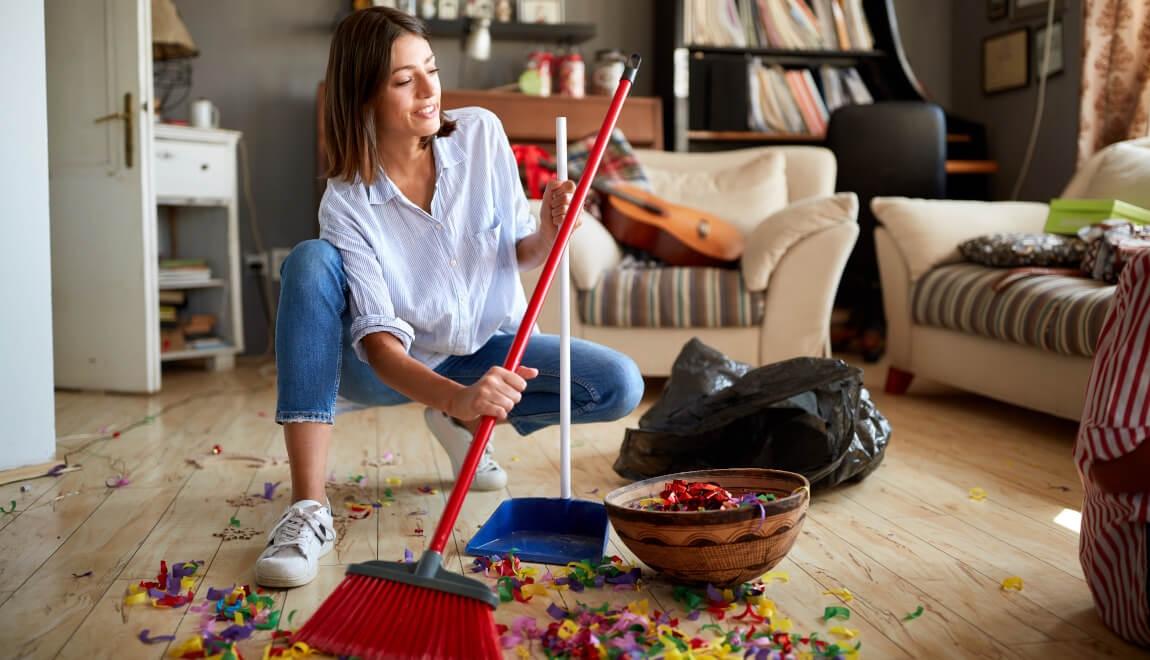 An image of a woman sweeping up confetti.