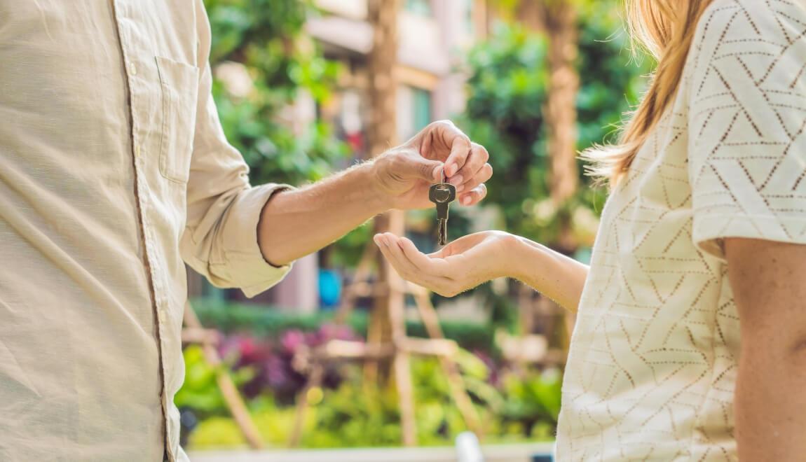 A person hands a key to a friend.