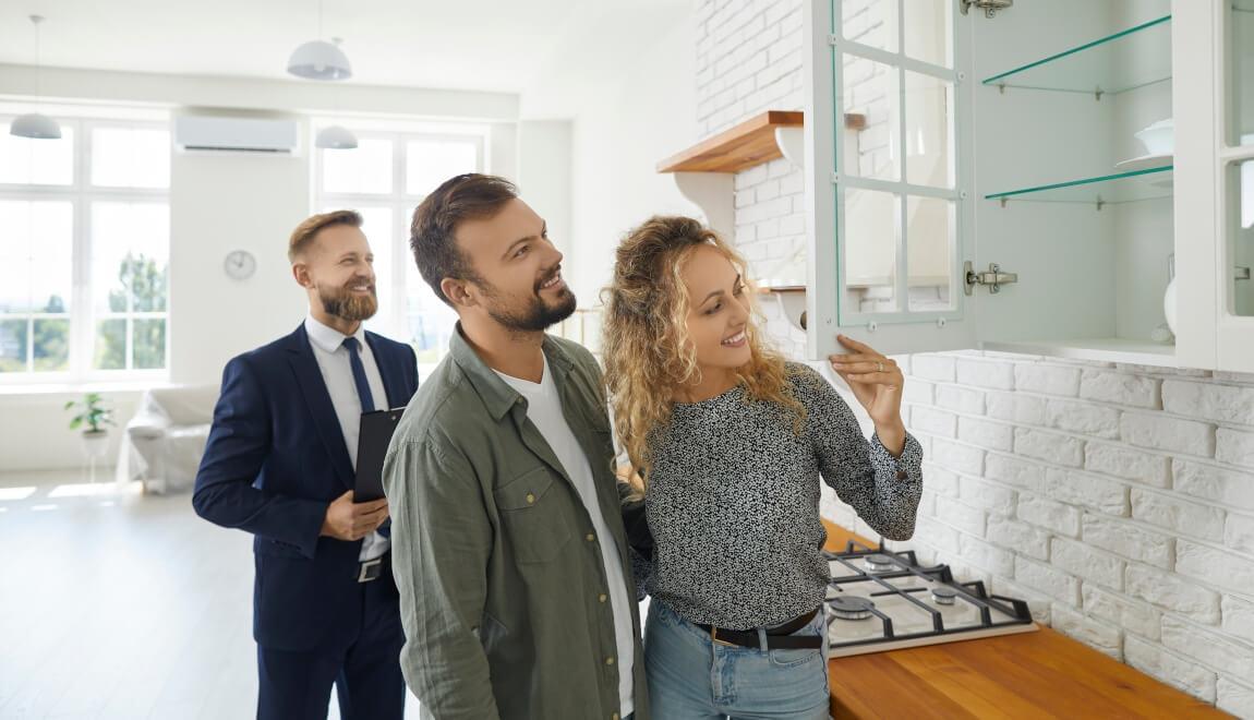 Renters tour an apartment with a leasing agent.