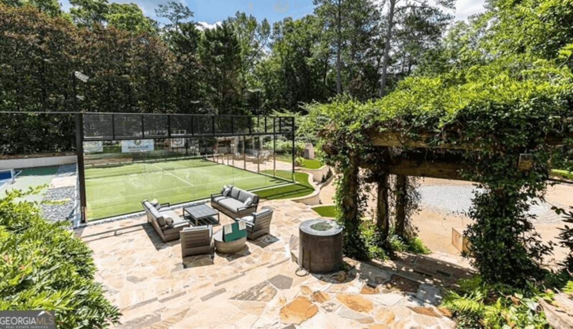 225 Valley Rd NW has a private paddel court, tennis court, and putting green in the backyard.