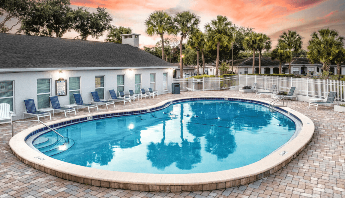 Palm trees reflect in the pool at Summit West in North Tampa.