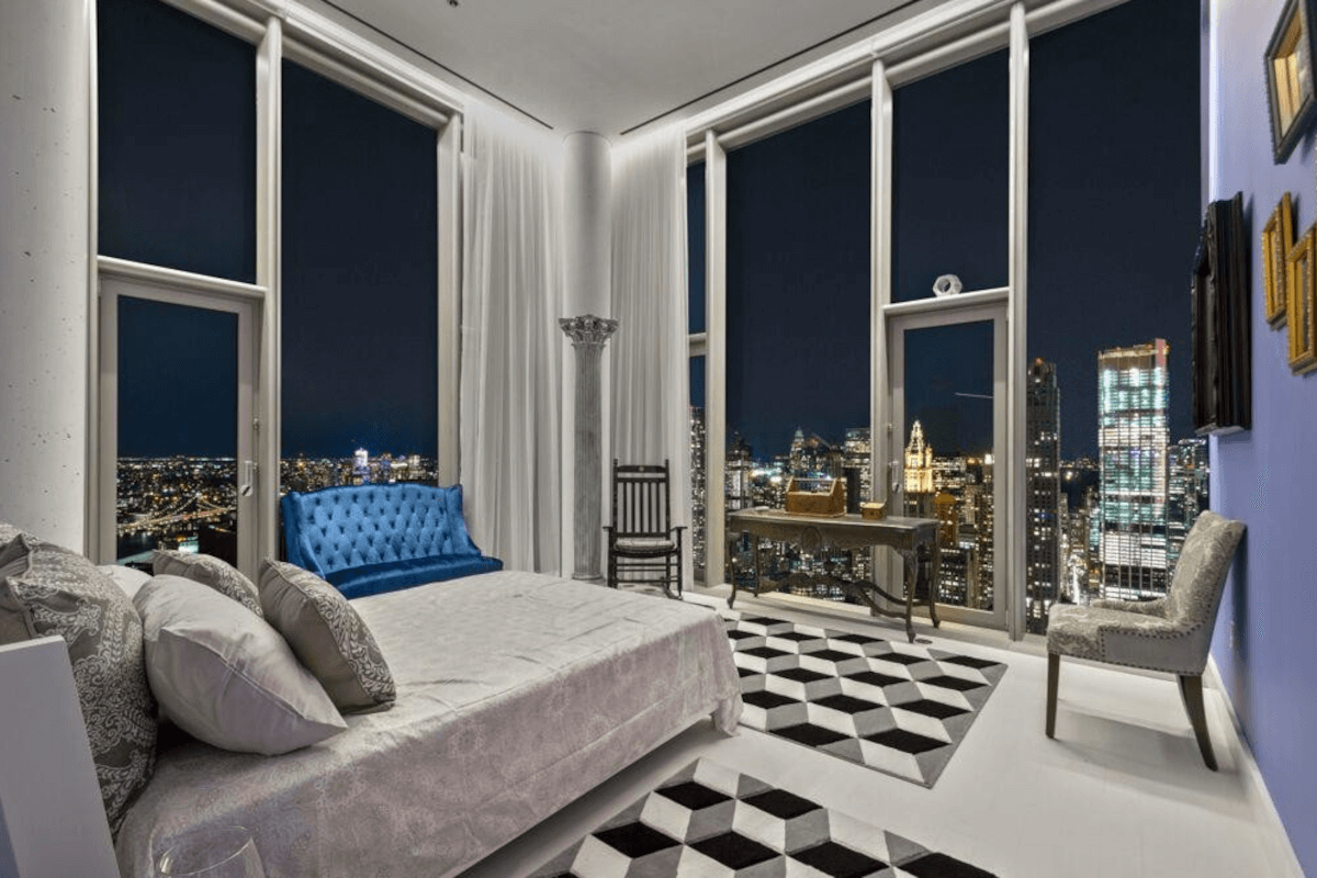 A bedroom at 56 Leonard Street gives residents a view of the city lights at night.