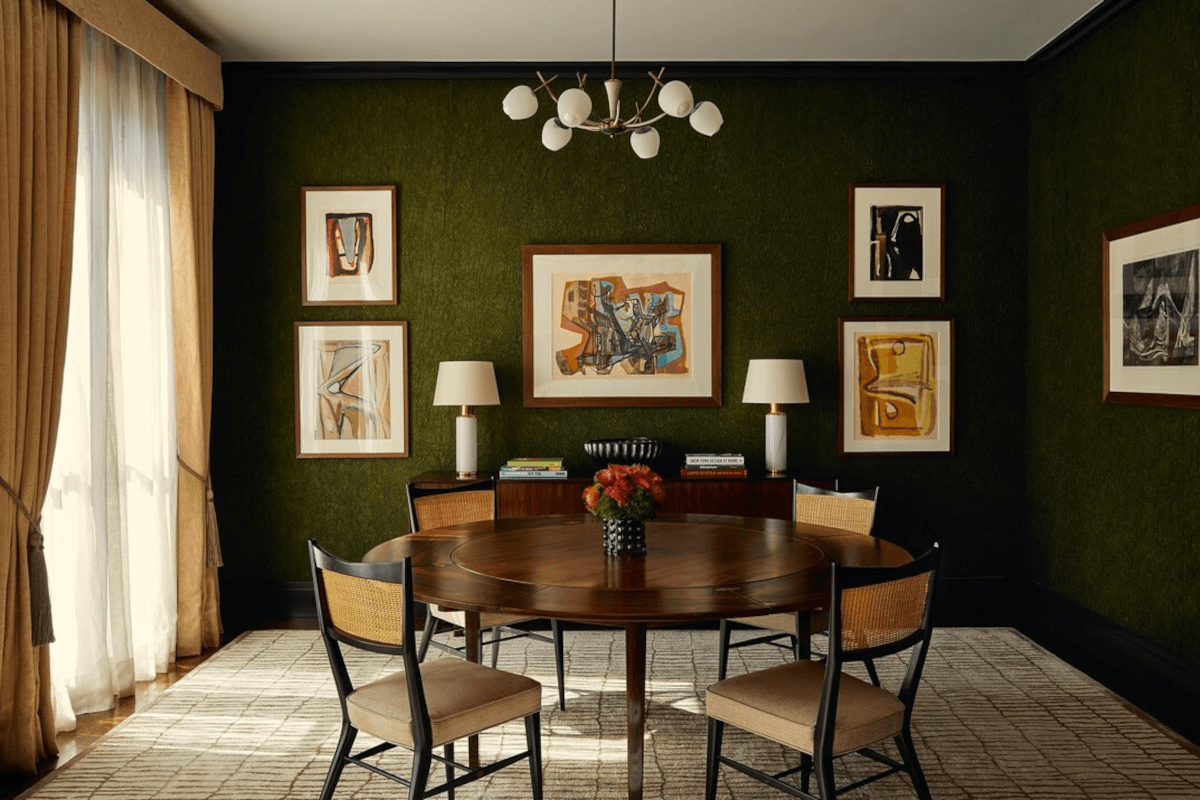 The dining room at 815 5th Ave features dark green walls and abstract art.