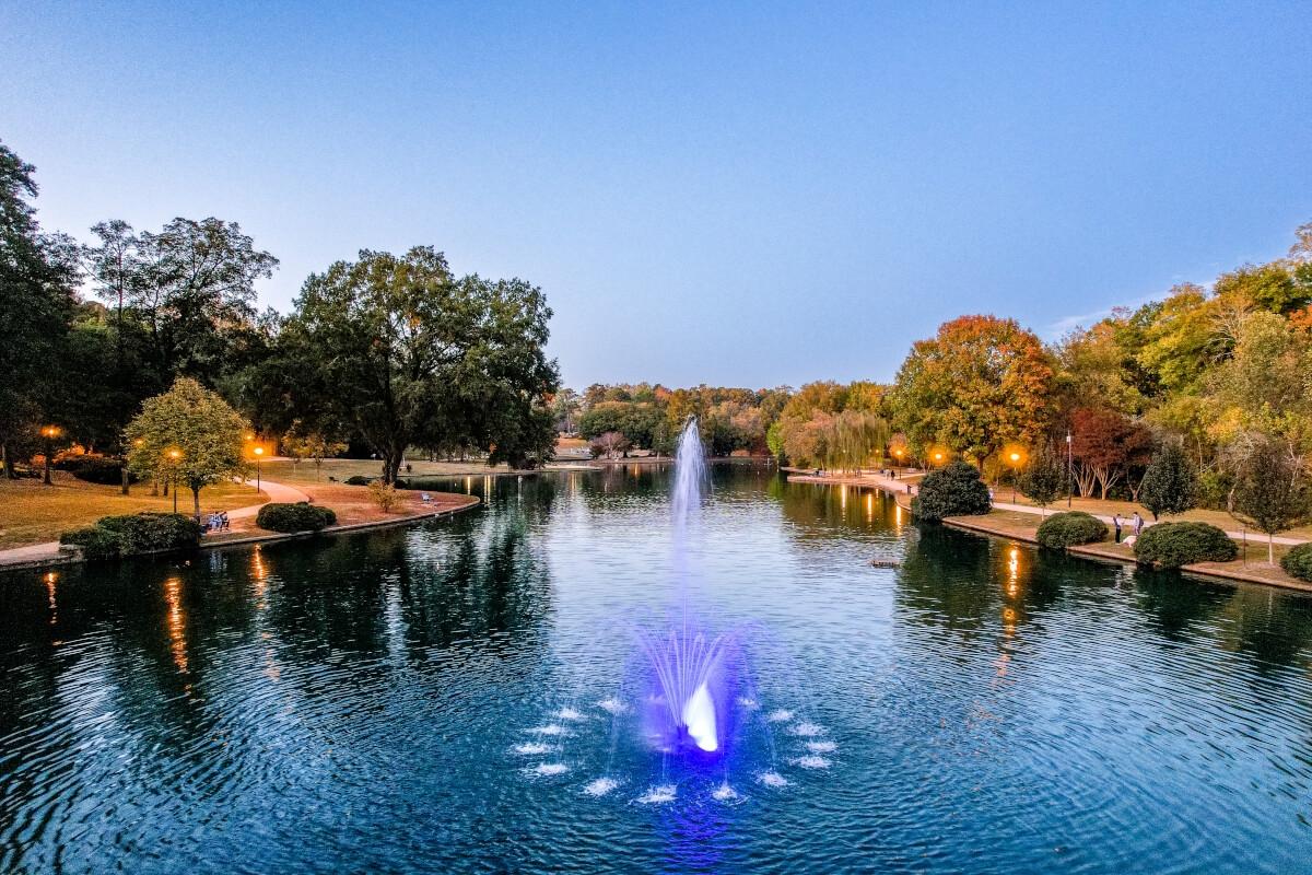 A lake with fountains sits in the center of Freedom Park in Charlotte, North Carolina.