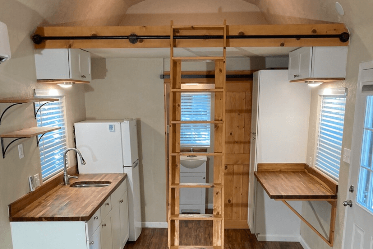 A moveable ladder provides easy access to the loft above the kitchen.