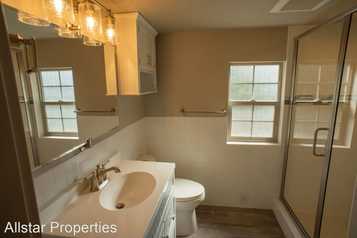 The bathroom in 408 North Main Street has pendant lighting and plenty of cabinet space.