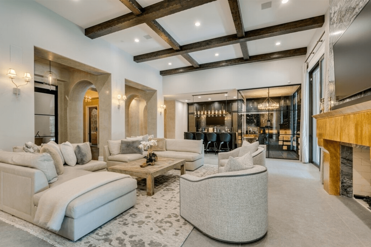 The living room at 47 Olympia Hills Circle leads to the gourmet kitchen and jewel box-style wine room.