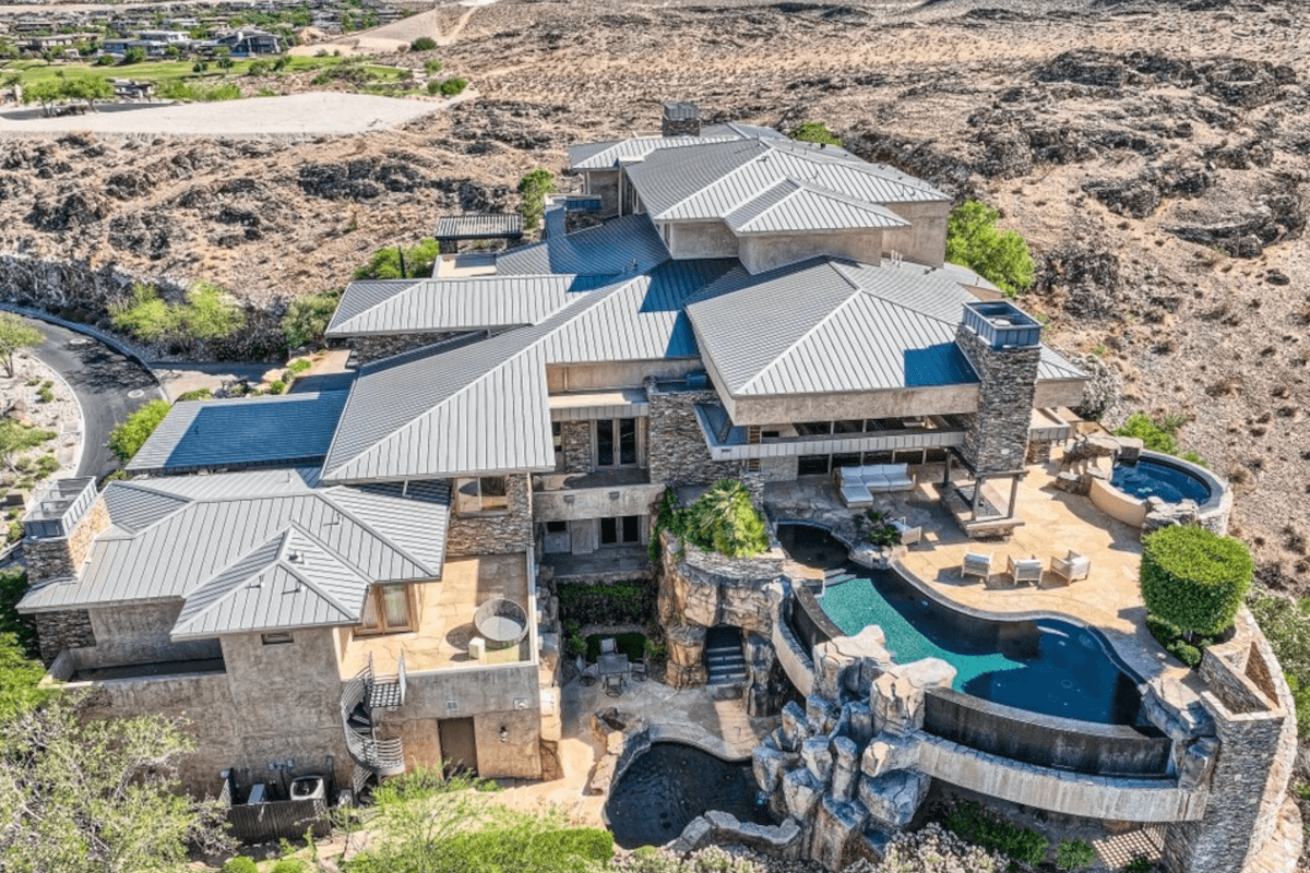 A waterfall connects the two pools at 5 Promontory Pointe Lane.