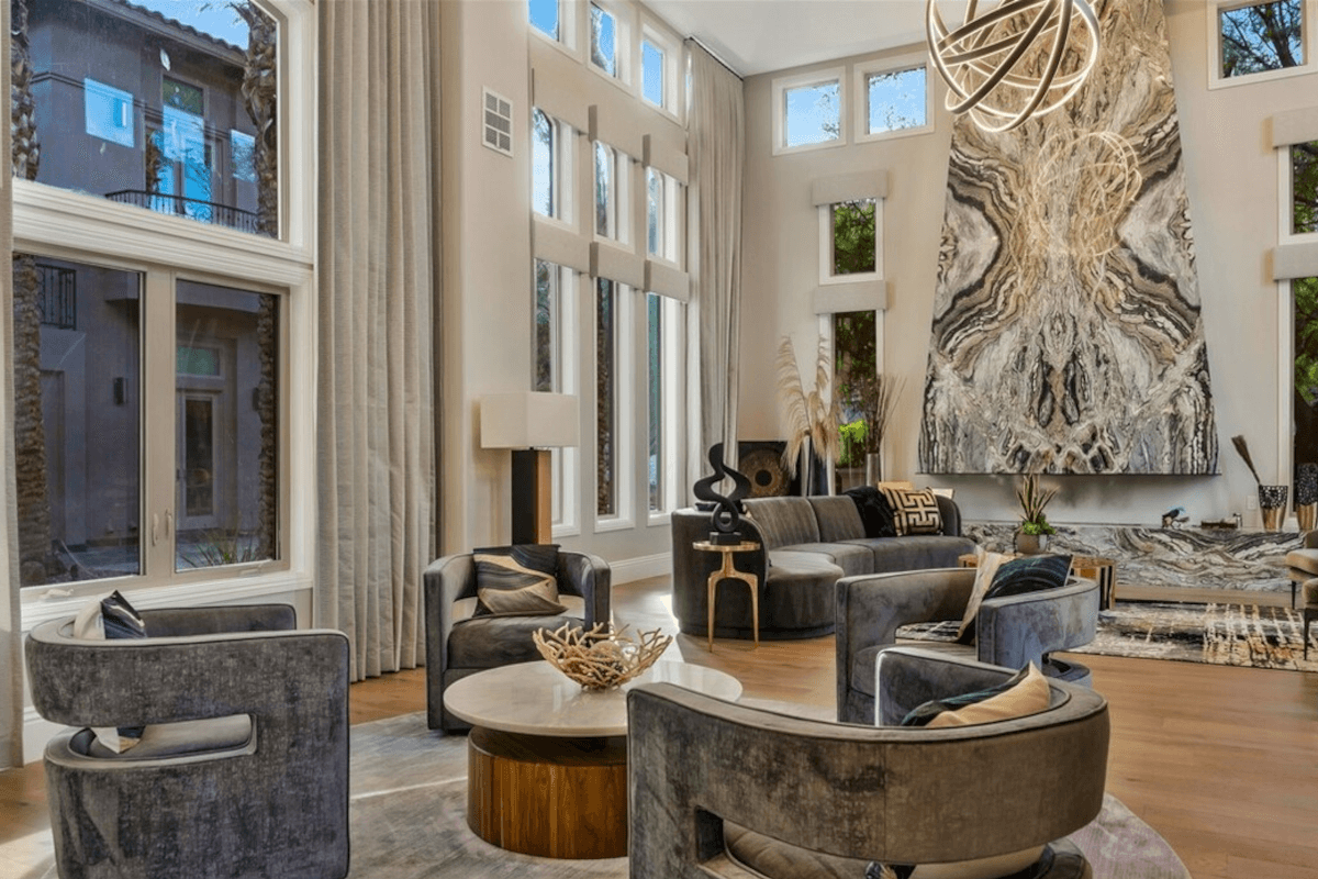 The two-story living room at 5 Wood Creek Court is the peak of modernity, with abstract sculptures and unique light fixtures.