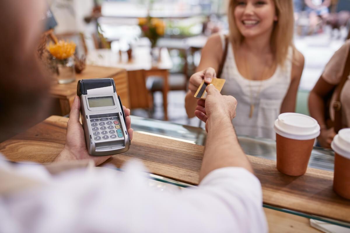 A woman pays for a coffee with her credit card.