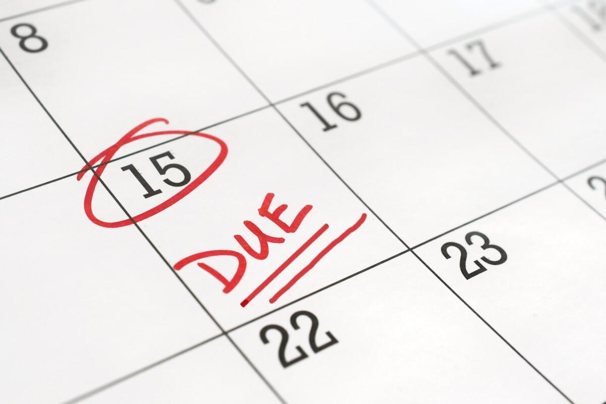 The 15th of a month is circled on a calendar with the word "DUE" in written in red.