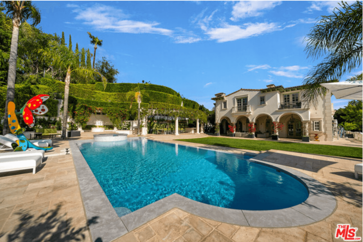 The lush landscaping around the pool at 1141 Summit Drive makes this Italian-style villa feel just like the Mediterranean.