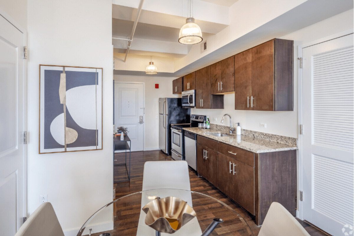 Kitchens in The Beacon Jersey City have stainless steel appliances and pendant lights.
