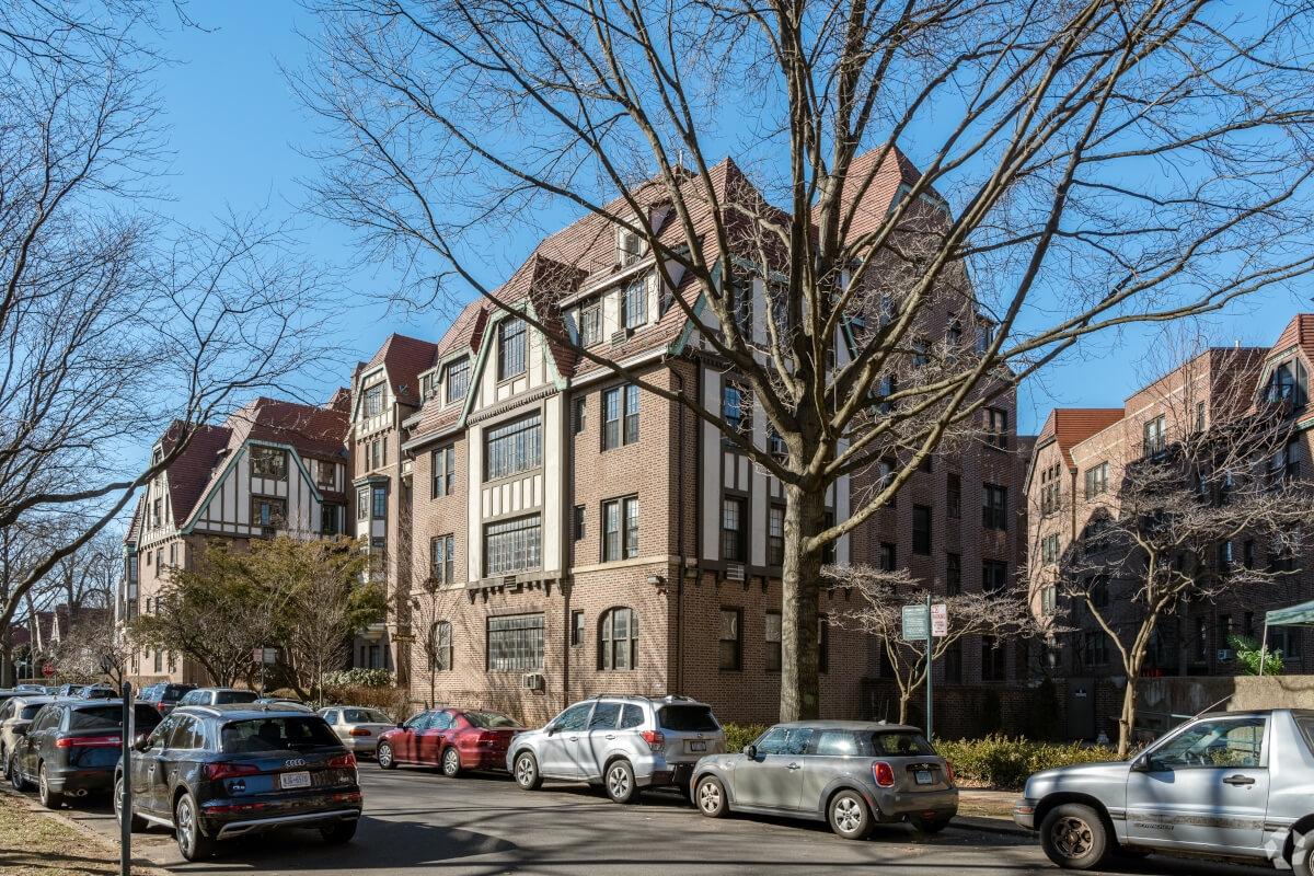 A Tudor-style apartment building sits on a quiet street in Forest Hills.