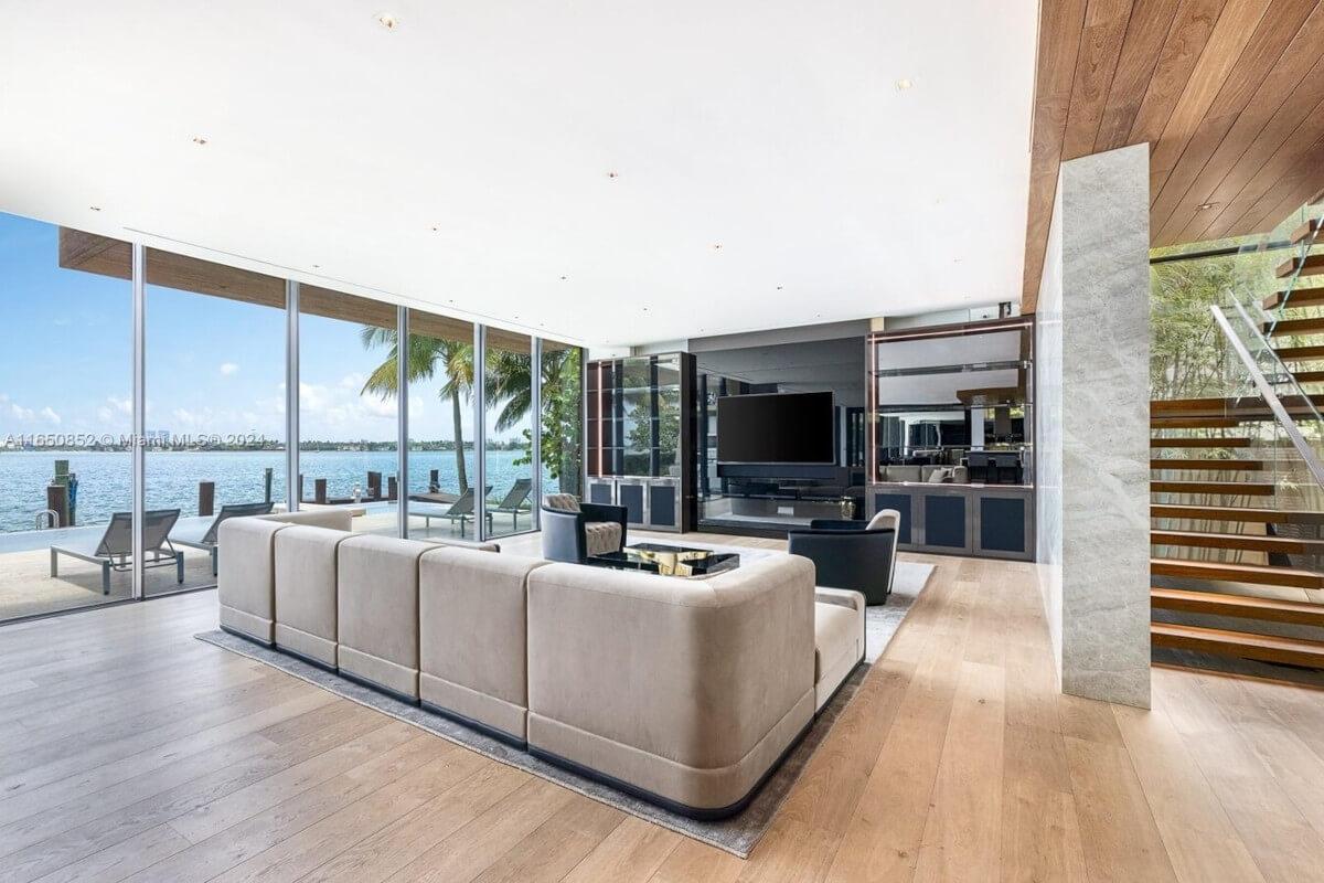 Floor-to-ceiling windows at 825 East Dilido Drive give panoramic views of Biscayne Bay.
