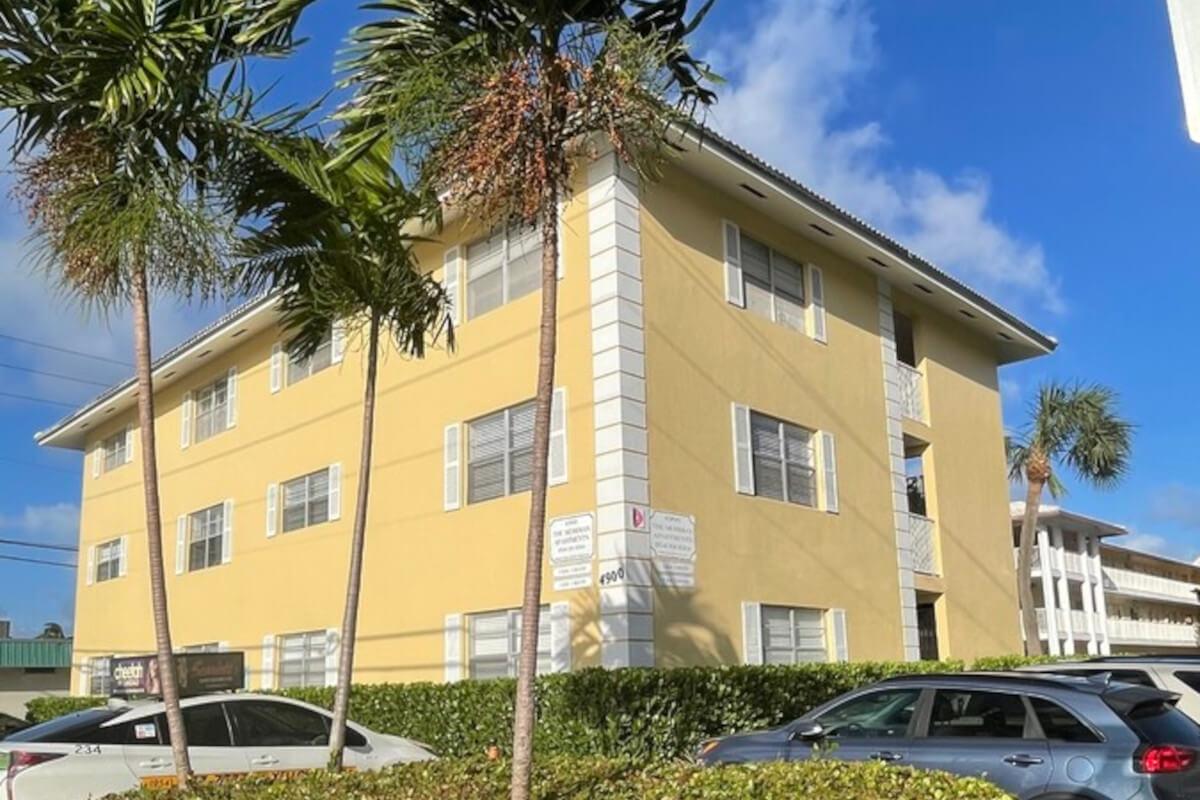 The Meridian Apartments community is made up of bright yellow buildings.