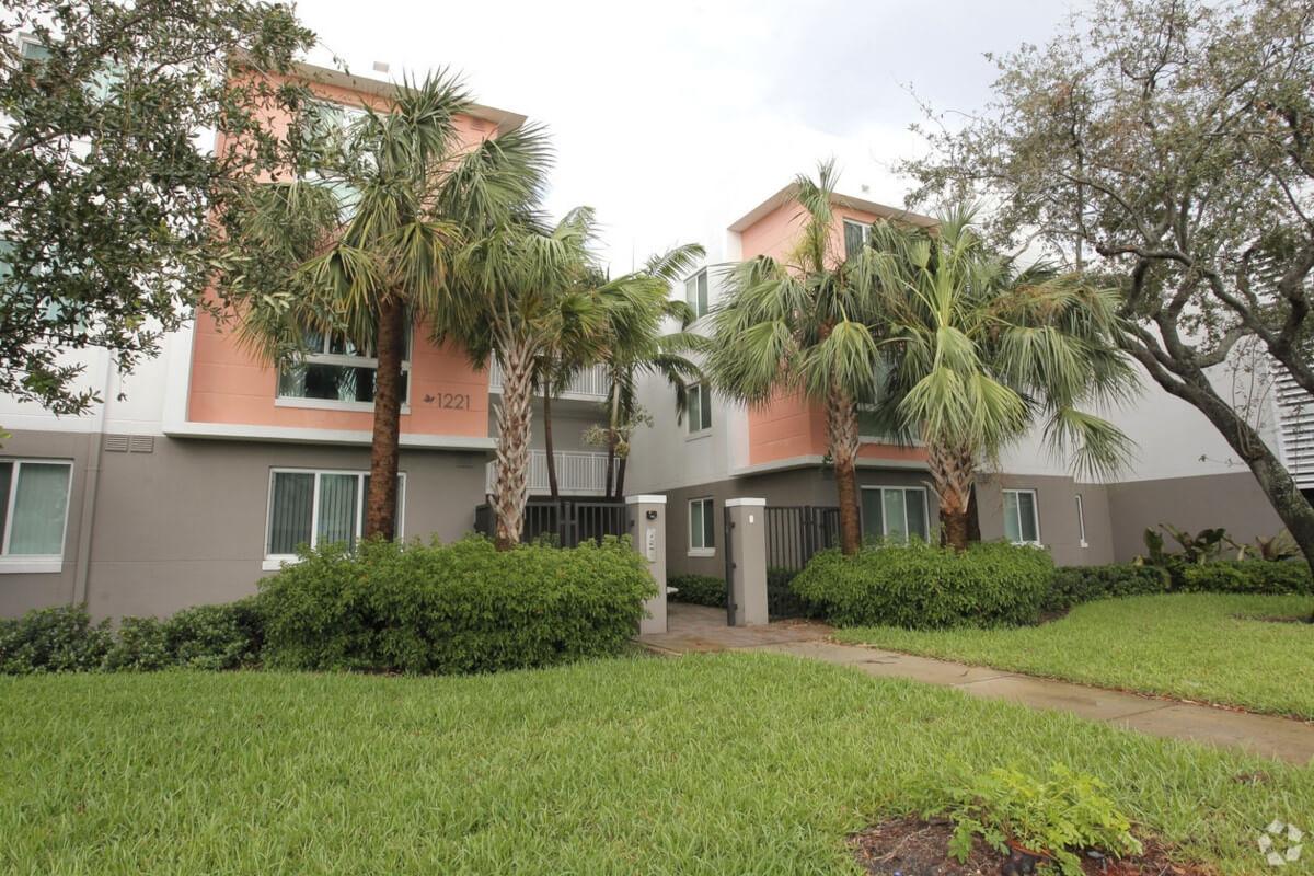 The Northwest Gardens IV apartment community has palm trees outside of its buildings.