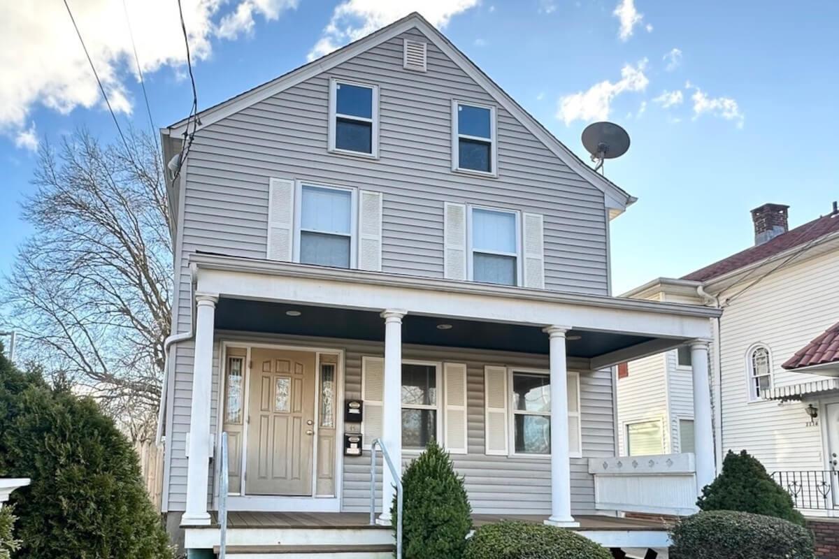 Four columns stand in front of the spacious front porch at 1112 Whalley Ave Unit 1.