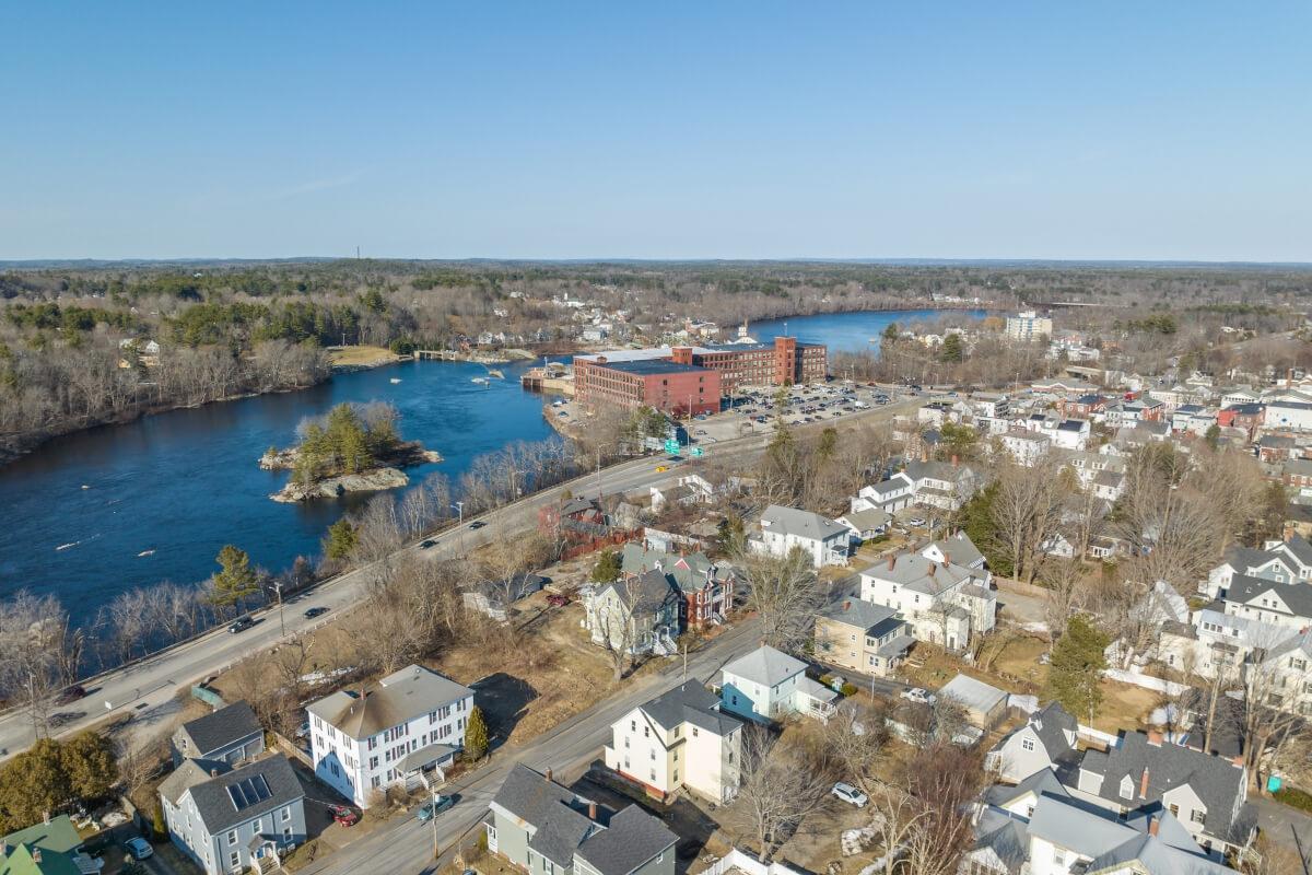 An aerial view of Brunswick, Maine, shows a residential area along the Androscoggin River.