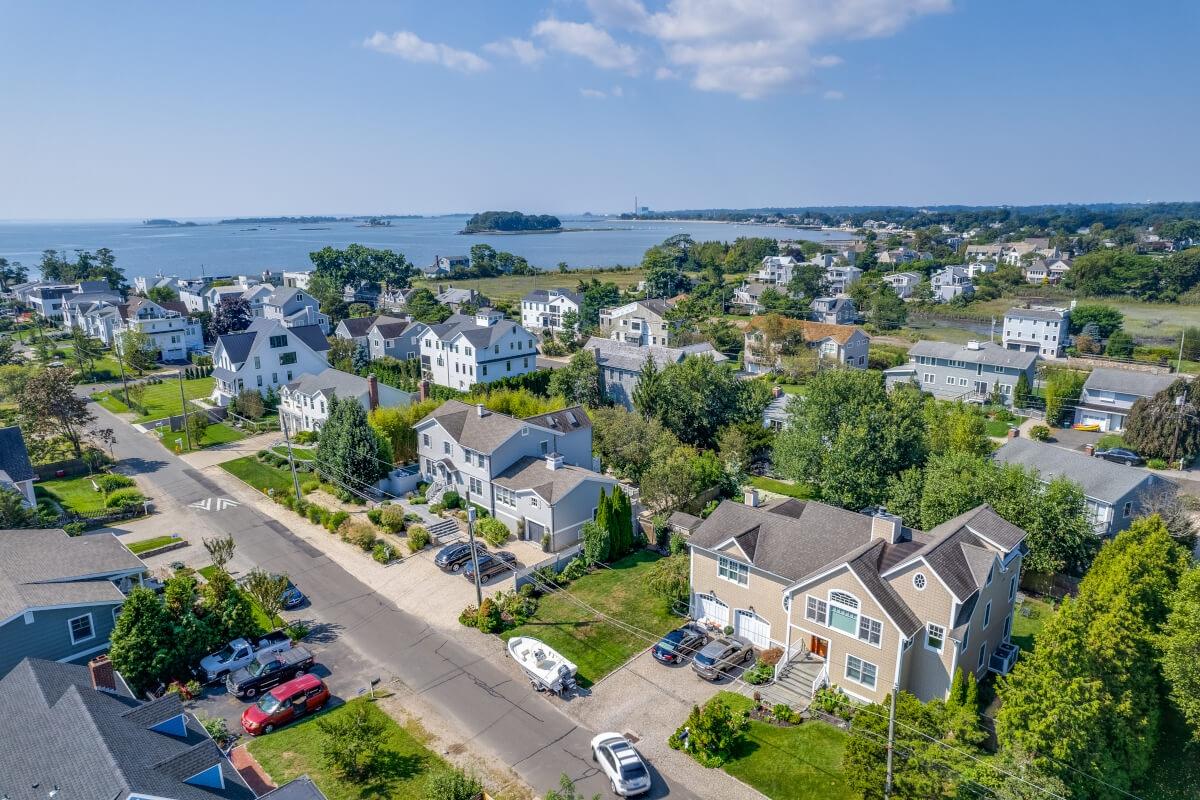 Rows of upscale homes in Westport lead to Long Island Sound in the distance.