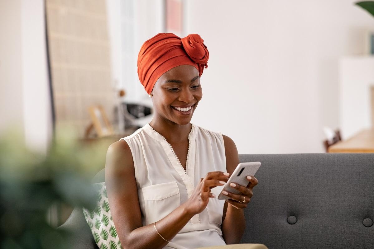 A young woman browses the internet on her smartphone. 