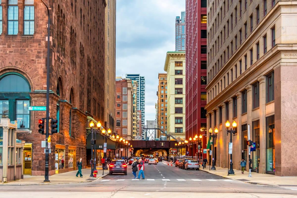 Busy street in Chicago with tall buildings on both sides.