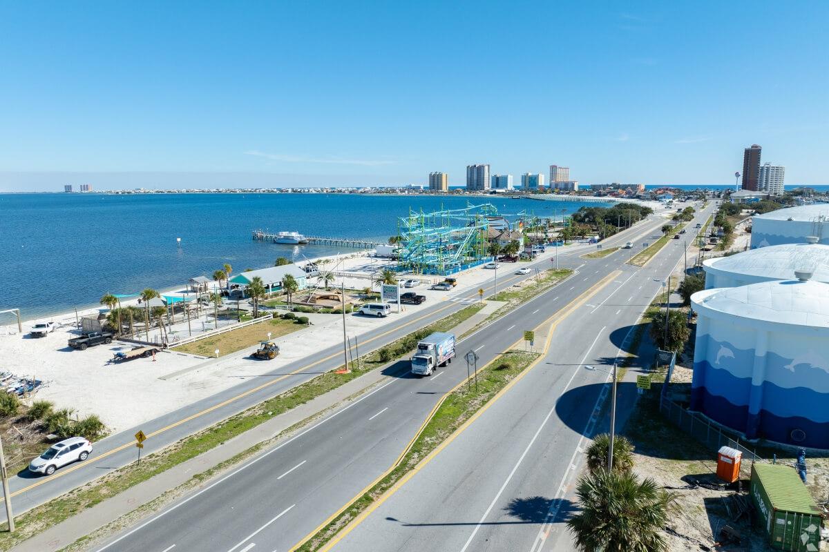 An aerial view of Pensacola Beach shows bright white sands and sparkling blue water.