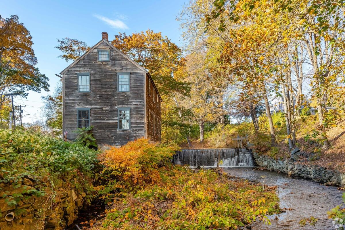 Moffett Mill is surrounded by vivid red and gold foliage in the fall.