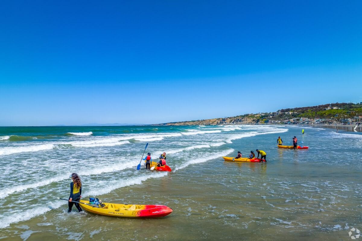 Kayakers getting into the water at La Jolla Shores Beach.