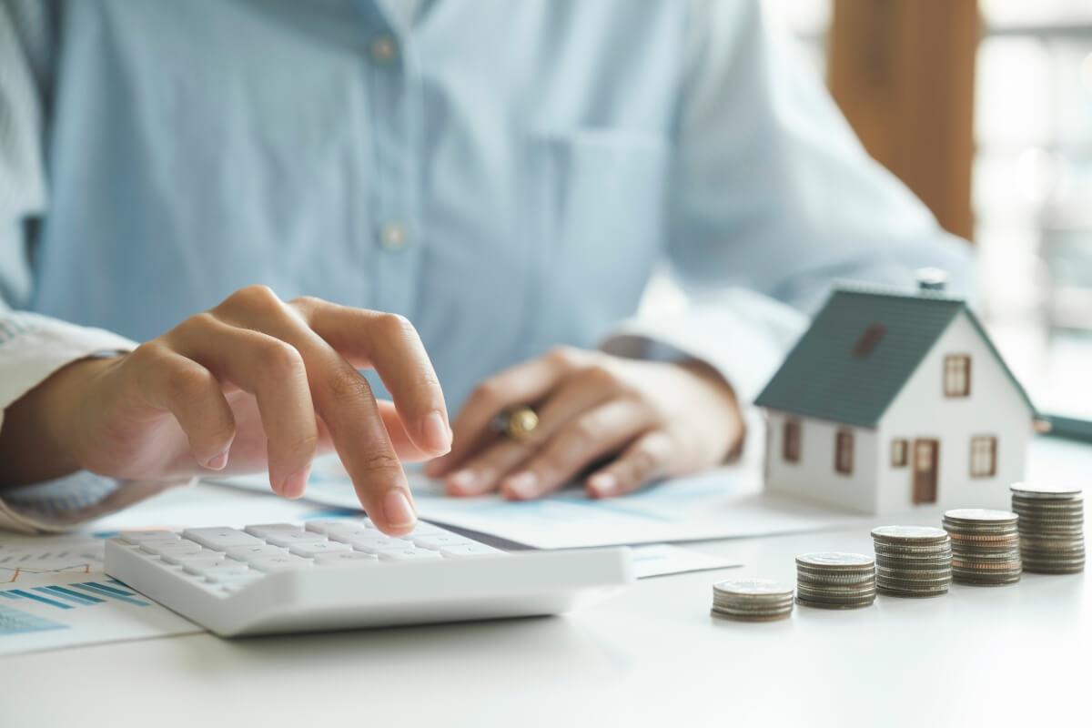 Person calculating their rent on a calculator