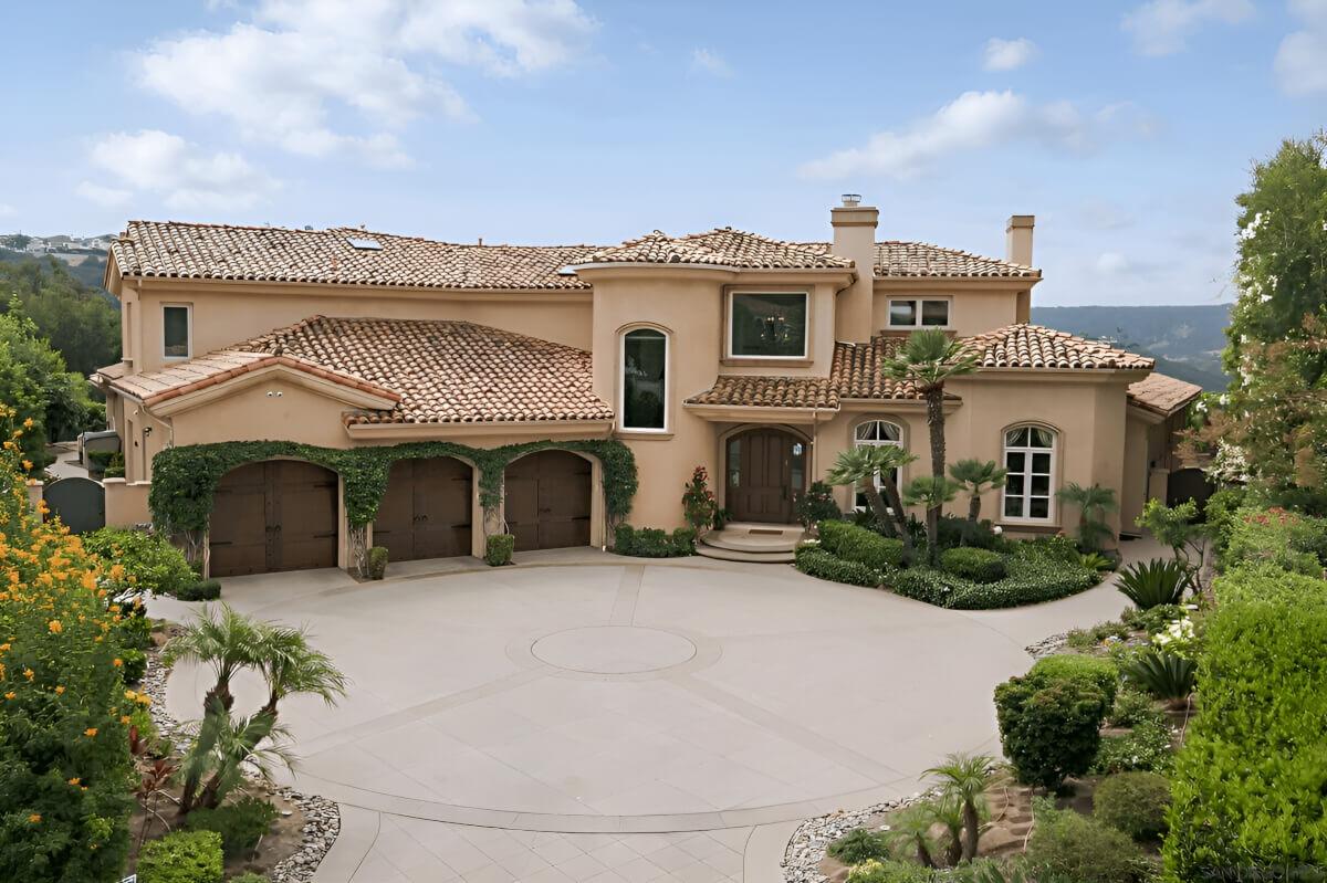 5106 Meadows Del Mar has three garages and a large front driveway.