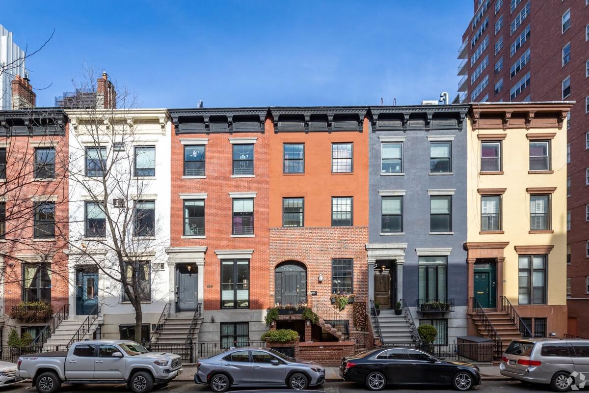 Cars are parallel parked in front of row houses in Kips Bay.