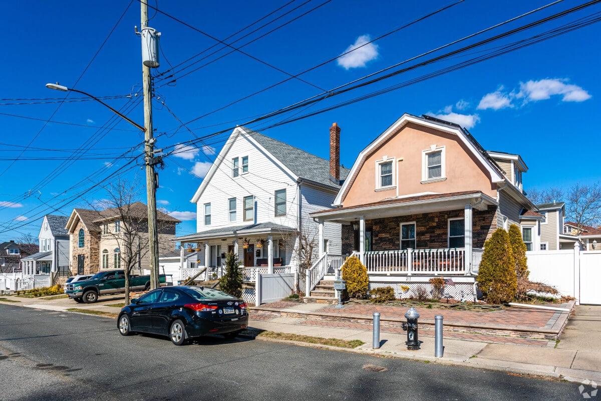 A car parallel parked in front of unique single-family homes in Tottenville.