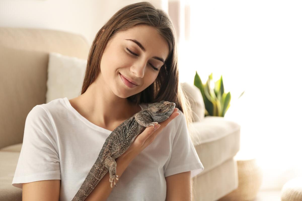 Renter holds gecko in her apartment.