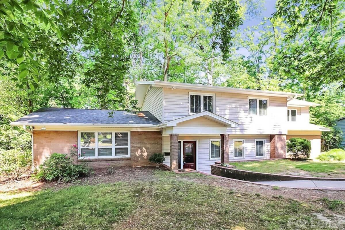 2619 Inverness Rd is a mid-century-style home surrounded by trees.