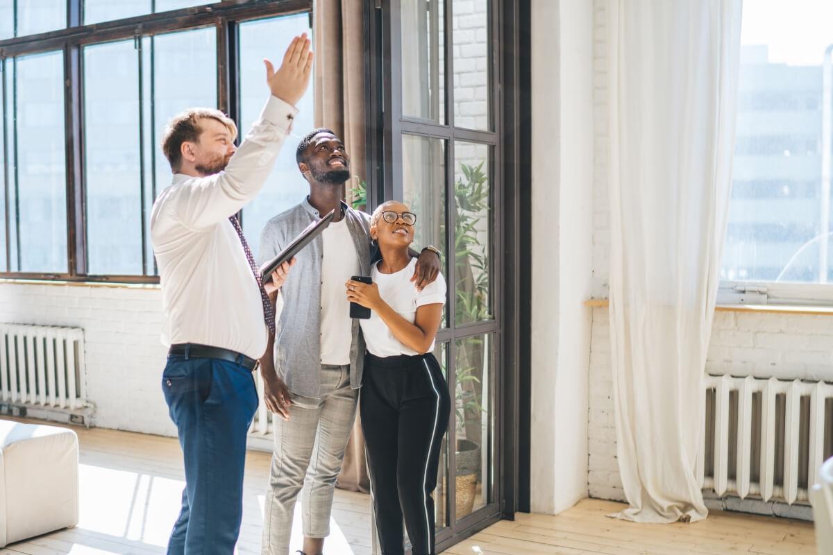 A couple being shown an apartment by the landlord.