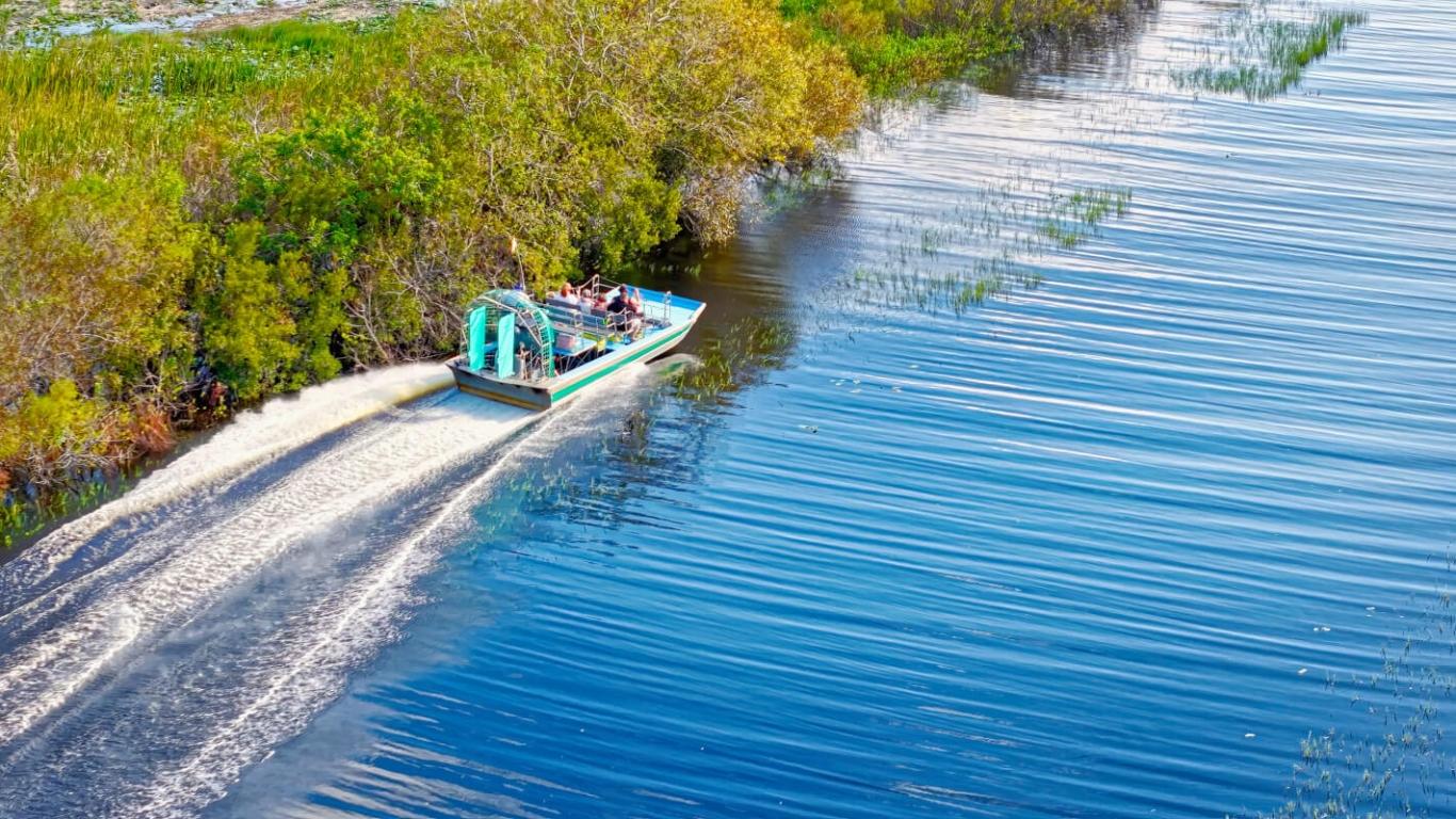 The a boat speeding along the watery Everglades in Miami, FL