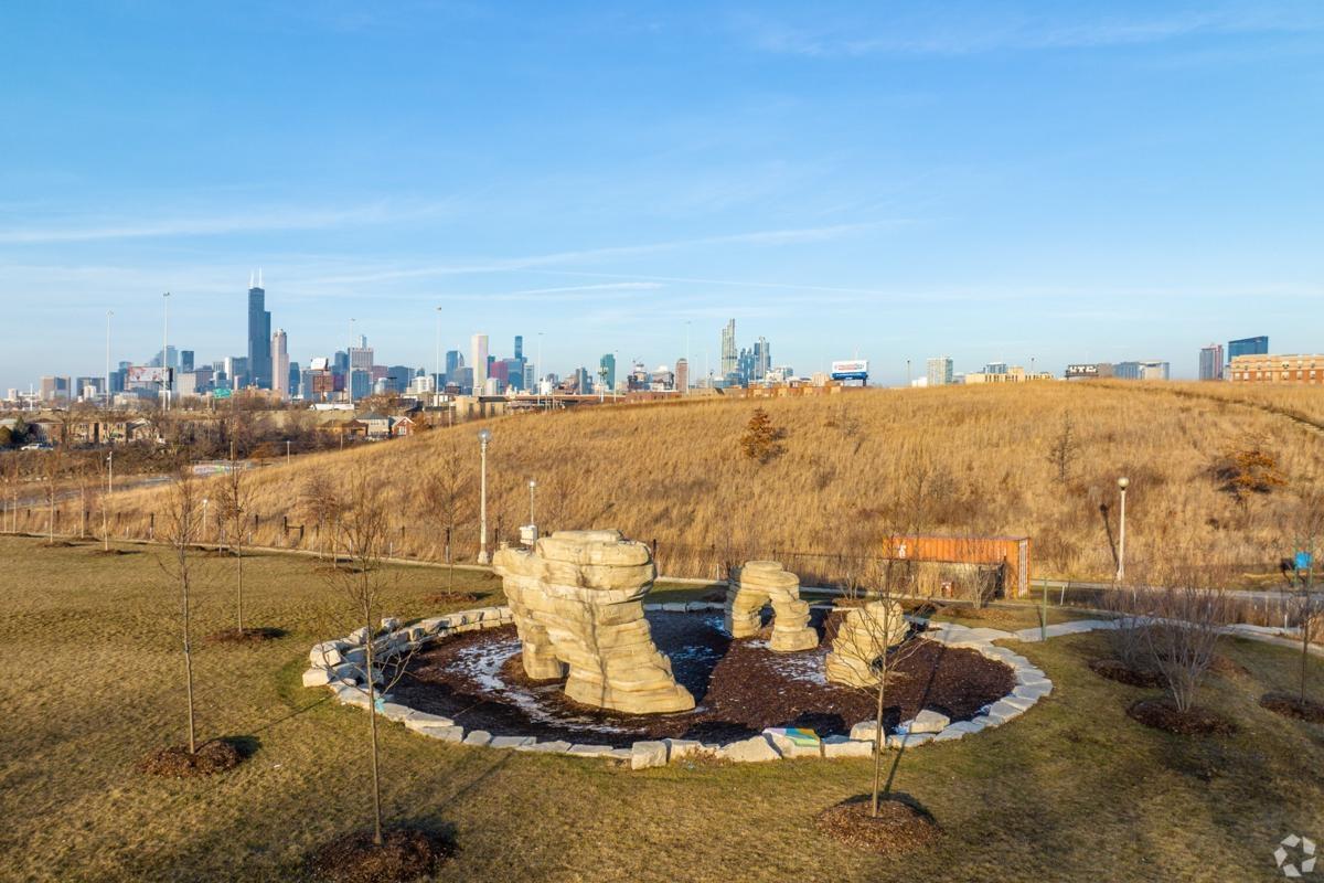 Scenic view of the natural area in Bridgeport with rock formations and Chicago skyline, perfect for outdoor relaxation near city apartments.