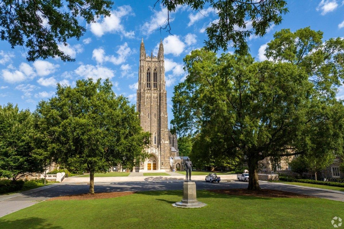 Duke University Chapel surrounded by trees and blue skies on the Durham campus.